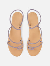 Flache Ringsandalen mit lila Strasssteinen